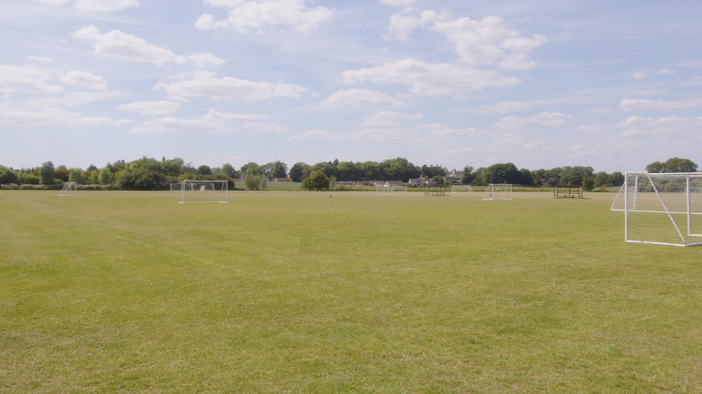 Image of wales high school playing field with diggers